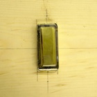 Close-up picture of one of the doorbell buttons in the experiment.
		This button has a large brass rectangular pressable part. The whole top face of the button is
		pressable.